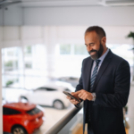 A dealer using technology to help him purchase a vehicle