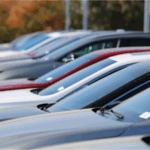 A group of vehicles on a dealer's lot waiting to be sold