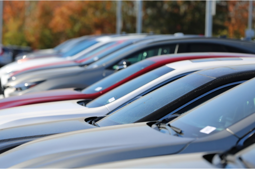 A group of vehicles on a dealer's lot waiting to be sold