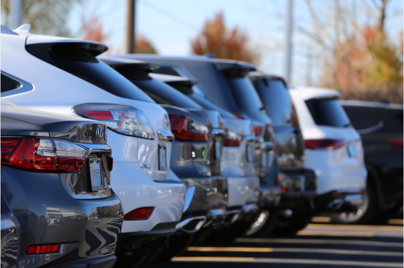 A picture of several vehicles sitting on a dealer's lot