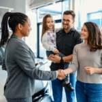 A family works with a car dealer to purchase a vehicle