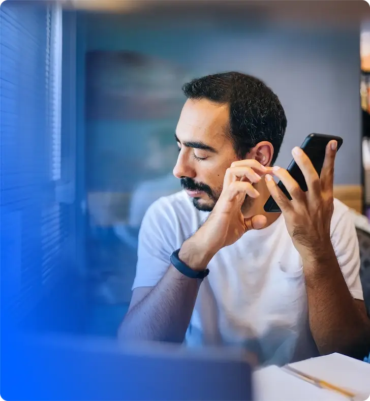 A dealer listening to an engine recording on the phone
