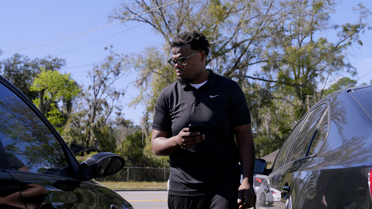 Dealer inspecting cars
