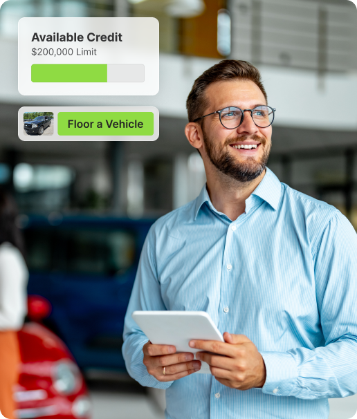A smiling man in a blue shirt holds a tablet. Overlay graphics show Available Credit $200,000 Limit with a green progress bar and a button labeled Floor a Vehicle next to a car image.